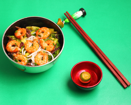 Vietnamese shrimp and rice noodles soup, pho on a green backgroundの写真素材