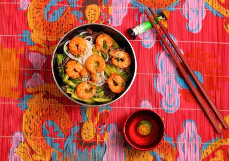Vietnamese shrimp and rice noodles soup pho, served on a bamboo place matの写真素材
