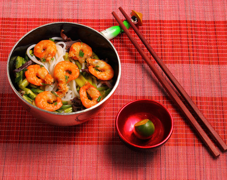 Vietnamese shrimp and rice noodles soup pho, served on a bamboo place matの写真素材