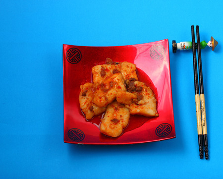 sirchuan style stir fried fish on a blue backgroundの写真素材