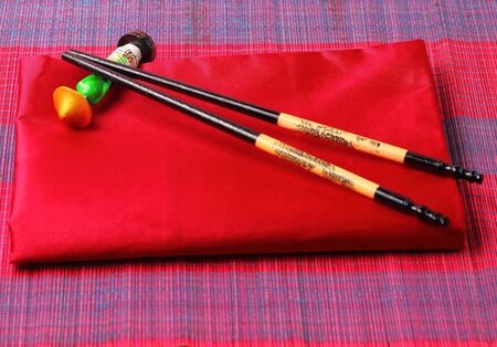 Traditional Vietnam table setting with chopsticks and red silk napkinの写真素材
