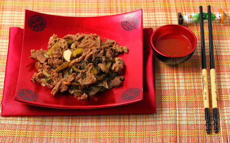 Vietnamese beef stir fry served on a bamboo place matの写真素材