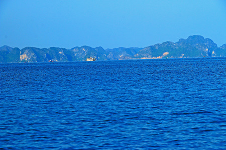 a view of rock formations and islands from ha long bay beach Vietnamの写真素材