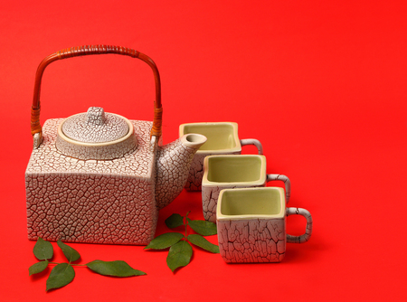 Asian tea set served on a red table clothの写真素材
