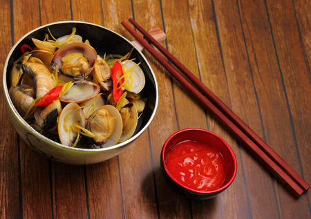 herbal clam soup Vietnam style served on a wood table topの写真素材