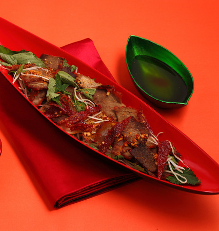 beef salad vietnamese style served on an orange backgroundの写真素材