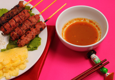 Vietnam beef on sticks served with salad with a pink backgroundの写真素材