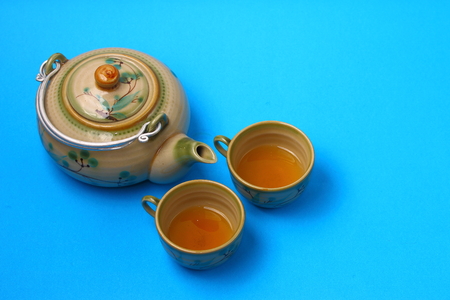 Asian tea set served on a blue table clothの写真素材