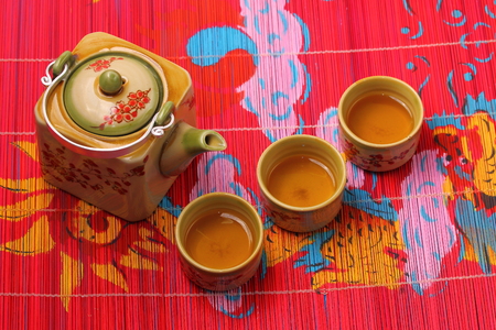 Asian tea set served on a bamboo place matの写真素材