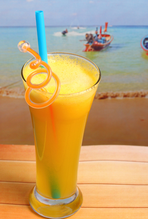 pineapple juice in glass on wood table top on an islandの写真素材