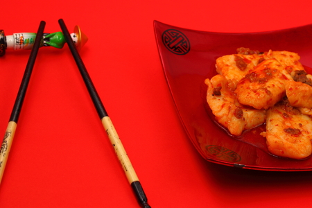 sirchuan style stir fried fish on a red backgroundの写真素材