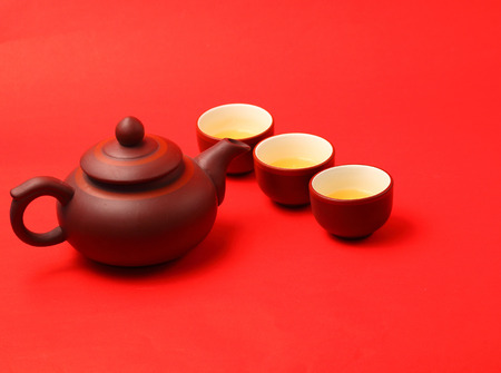Asian tea set served on a red table clothの写真素材