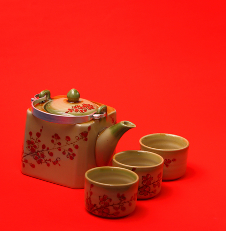 Asian tea set served on a red table clothの写真素材