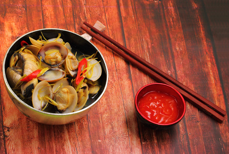 herbal clam soup Vietnam style served on a wood table topの写真素材