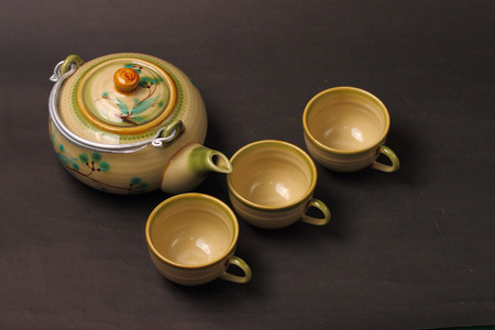 Asian tea set served on a black table clothの写真素材