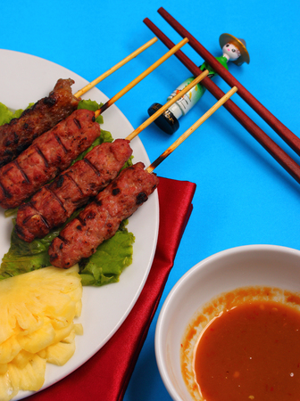 Vietnam beef on sticks served with salad with a blue backgroundの写真素材