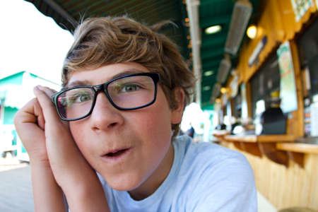 Fisheye portrait of a Teen Boy at a outside restaurant on the Peirの写真素材