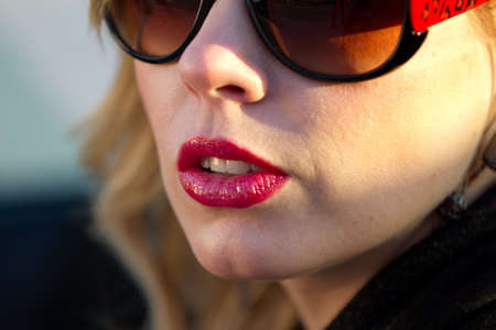 Outdoors Blond Woman closeup of Lips Nose and sunglassesの写真素材