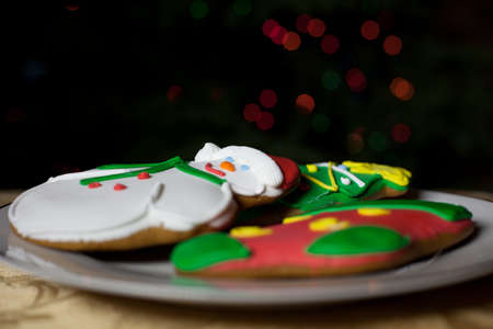 Christmas Cookies in front of the Christmas tree with bokeh from the lightsの写真素材
