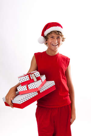 Cute Teenager giving a gift wearing a Santa Hatの写真素材