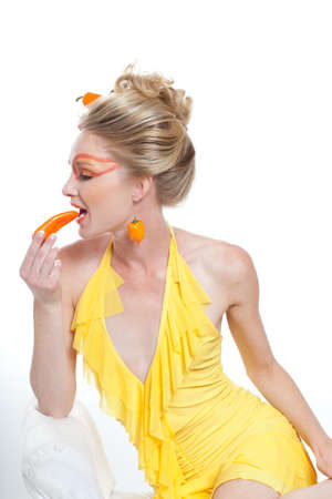 Beautiful Woman with hot and spicey Peppers and creative make-upの写真素材