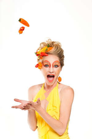 Beautiful Woman with hot and spicey Peppers and creative make-upの写真素材