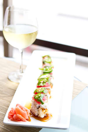 Sushi with tuna and a glass of White Wineの写真素材