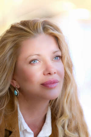 Pretty Woman with Long Hair in fall leavesの写真素材