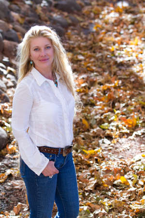 Pretty Woman with Long Hair in fall leavesの写真素材