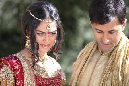 Image of a gorgeous Indian bride and groom traditionally dressedの写真素材