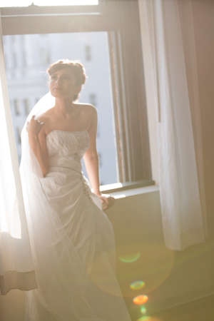 Beautiful Bride in the glow of natural light with intentional sun flareの写真素材