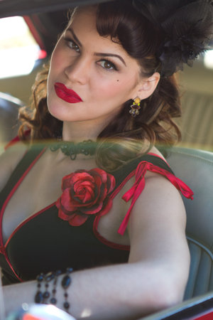 Beautiful Brunette woman driving a vintage car