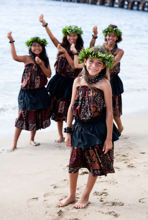 Hula girls on the beach with Hands raised in danceの写真素材