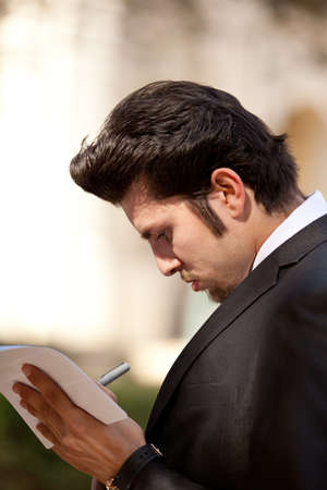 Handsome Guy in a Business Suit Signing Documentsの写真素材