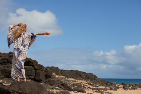 Sensual Woman wearing a Kimono at the Beach