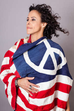 Woman draped in a Flag with a Peace Sign on itの写真素材