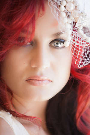 Beautiful Woman with Fiery Red Hair Lacw and Beads over her Eyeの写真素材