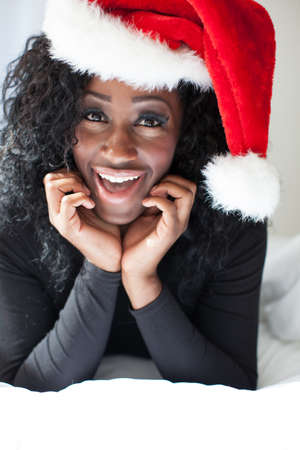 Beautiful Woman in Black wearing a Santa Hatの写真素材