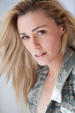 Pretty Camouflage woman feeling remiss for her soldierの写真素材