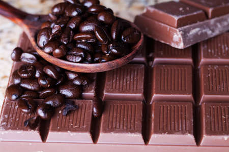 Chocolate and coffee Beans  in a wooden spoon for Christmas bakingの写真素材