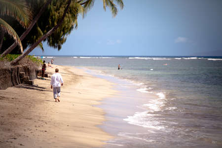 Man walking on a Beach in Maui aloneの写真素材