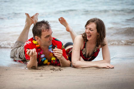 Couple on the Beach in Hawaii communicating in a playful wayの写真素材