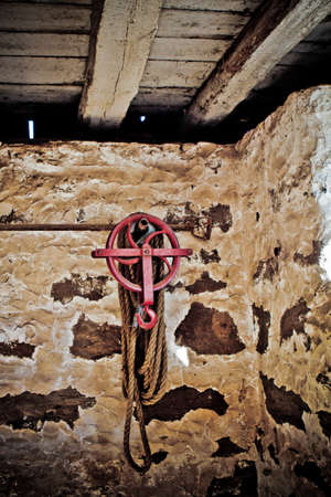 Old Vintage Hook, rope and cable in a barn with grain for vintage effectの写真素材