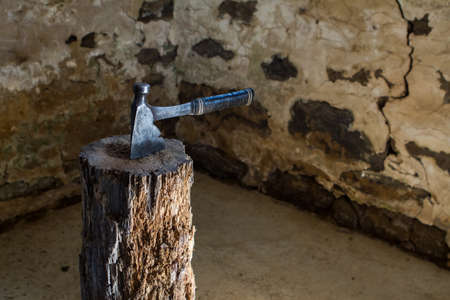 Vintage Axe on a chopping block log in an old barnの写真素材