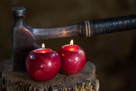 Apples as candles Vintage Axe on a chopping block log in an old barnの写真素材