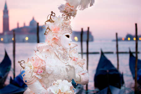 Sunrise in Venice Italy in front of Gondolas a Beautiful costumed womanの写真素材