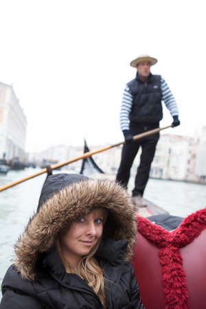 Beautifiul woman in Fur lined Jacket  riding on gandolaの写真素材