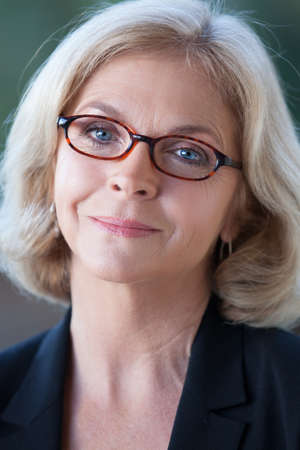 Beautiful Middle Aged Woman in her fifties looking at cameraの写真素材
