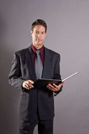 Handsome business man isolated on grayの写真素材