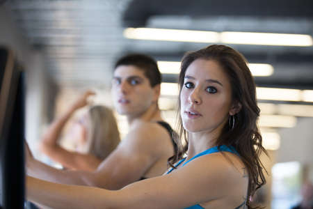 Attractive young woman in Blue at the Gym on stair steppersの写真素材